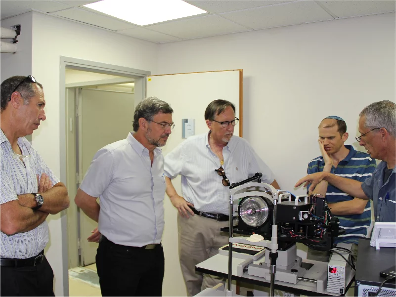 Members of the AdOM team with their device