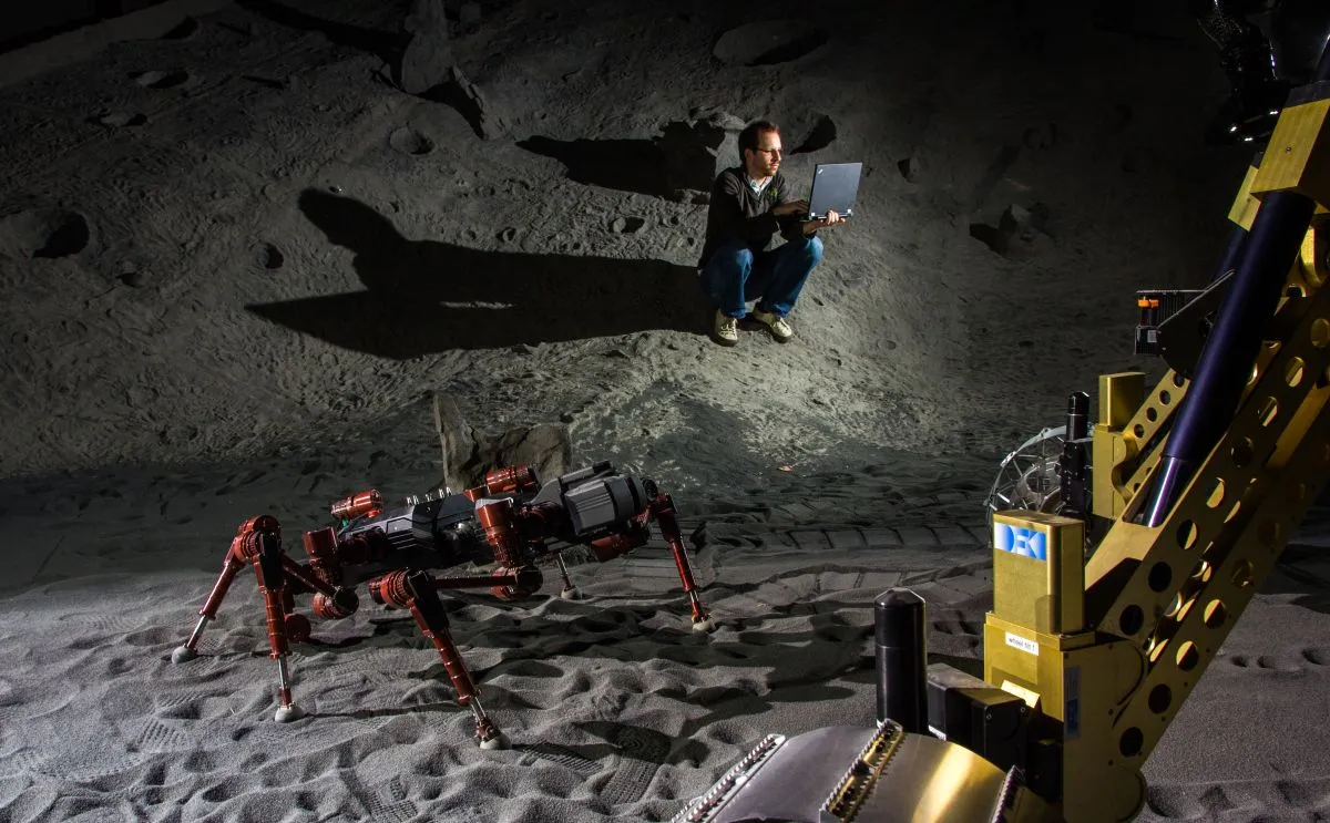 Robots and scientist in DFKI's artificial crater environment