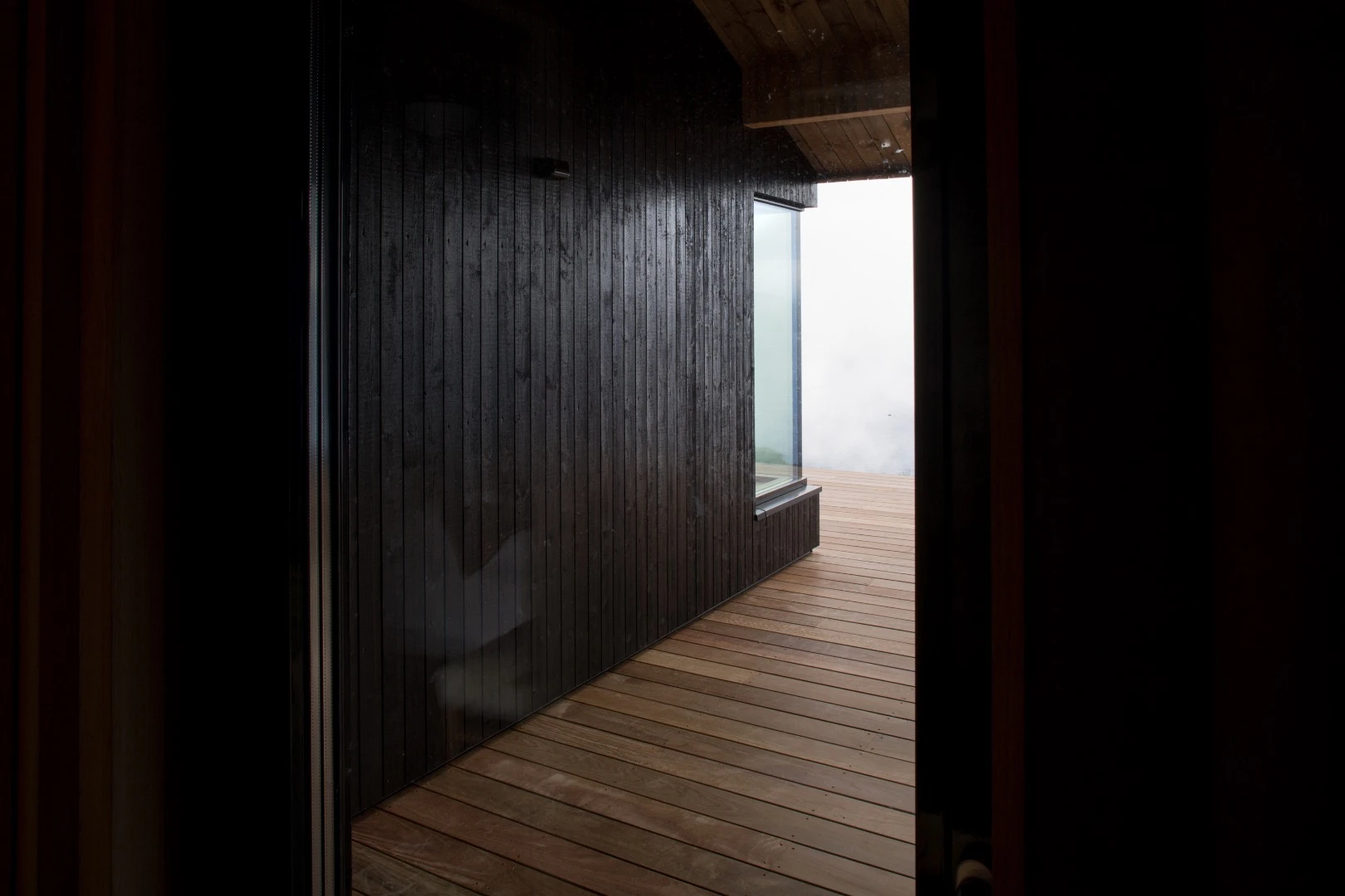 The Hooded Cabin's timber is partly painted black