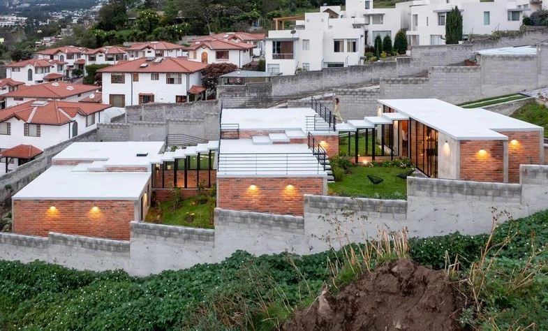 Ecuadorian architectural firm El Sindicato has recently created a unique family home built into a slope