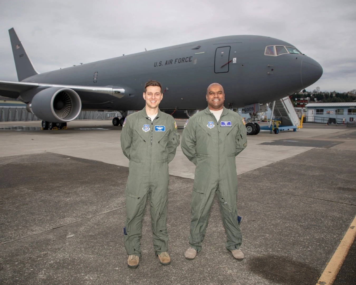 Nick Cenci, Major, USAF Chief of Flight Operations DCMA (Seattle) (left) and Anthony Mariapain, Major, USAF KC-46 Chief Pilot DCMA (Seattle) stand in front of the KC-46A Pegasus at Boeing Field in advance of the U.S. Air Force acceptance of Boeing’s first tanker