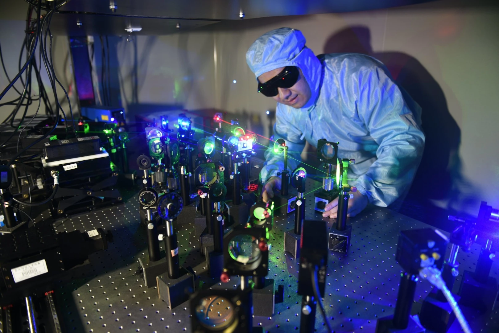 Lead researcher Shencheng Fu conducts experiments on a new film that can store data as 3D holograms