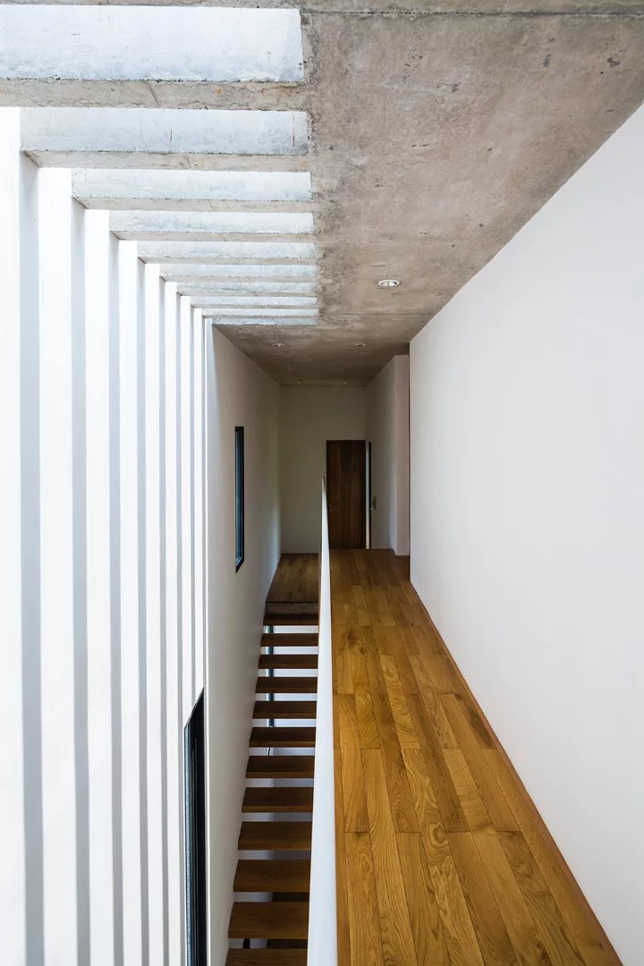 Binh House's service areas, like the kitchen, bathrooms, stairs, and corridors are located in the west to limit heat exposure in more important areas, like bedrooms and living room
