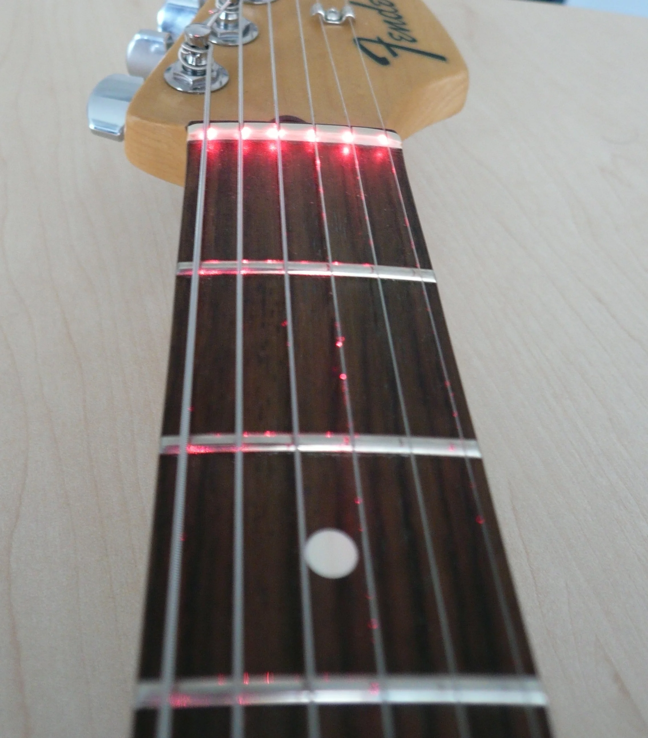 The LPD system uses lasers to monitor the fingerboard for changes in beam length along each string