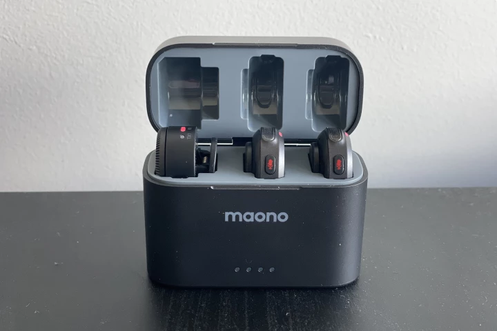 The charging case houses the two microphones and the camera receiver