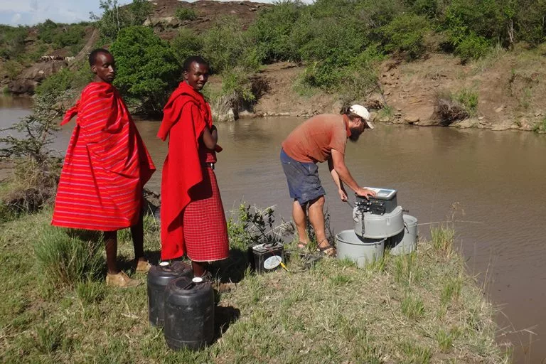 Lead research Christopher Dutton collects samples from a hippo pool