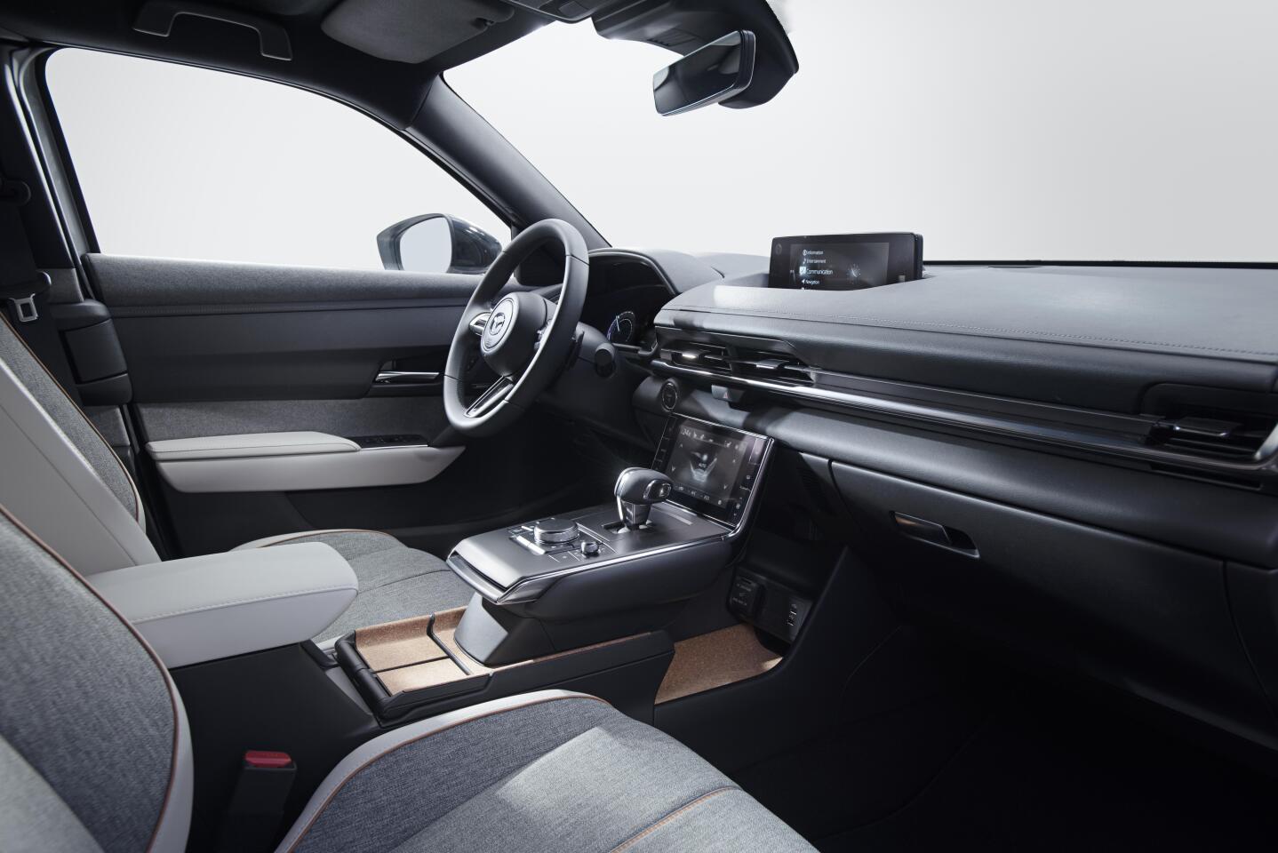 The simple dashboard in the MX-30 features two screens, one ahead of the shifter for climate controls, and one on top of the dash for infotainment