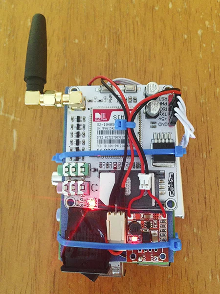 The rear of the PiPhone shows the GSM module, SIM card slot and two strategically-placed cable ties that hold the device together