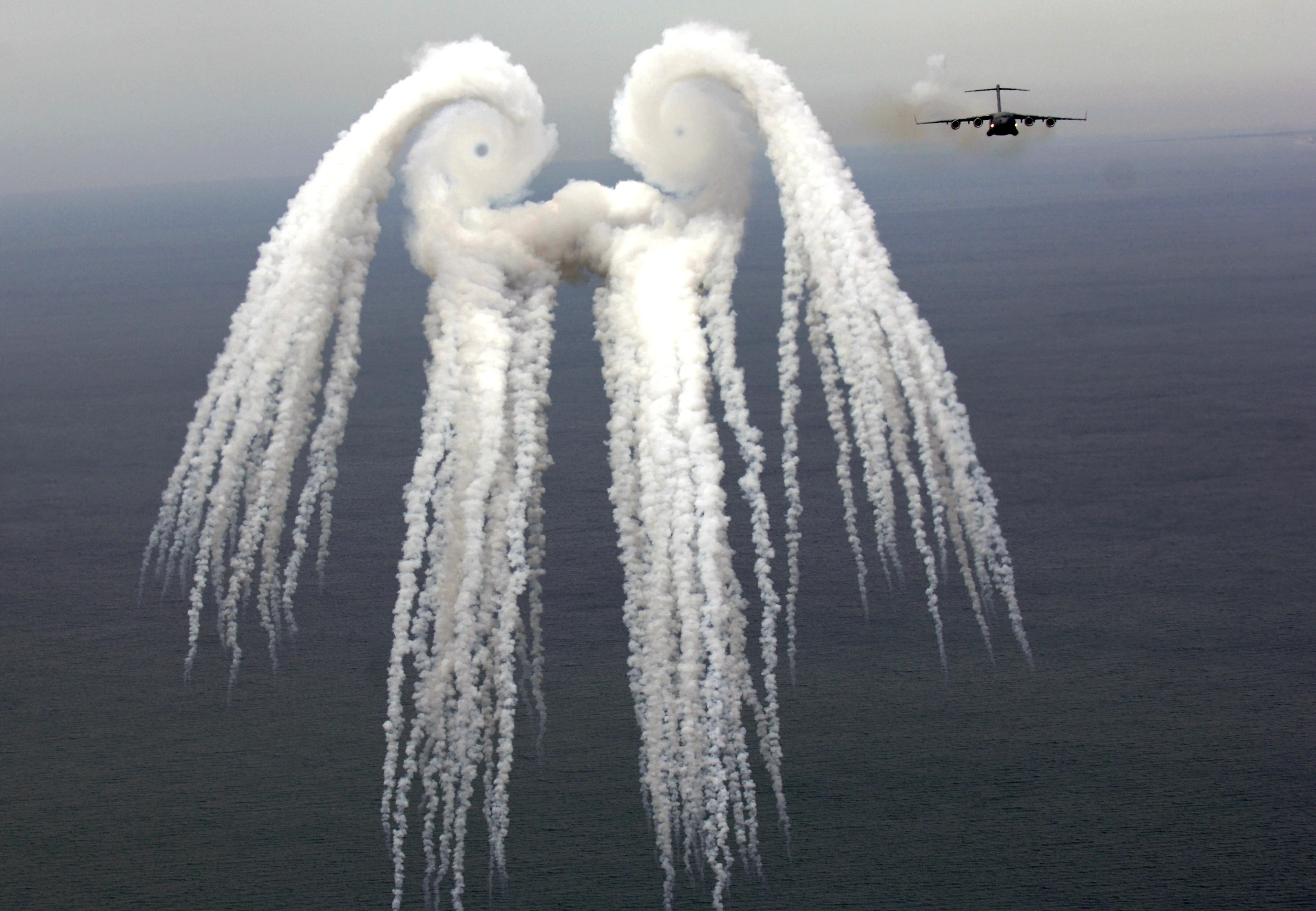 C-17 generating vortices in smoke trails of flares (Image: US Air Force/Tech. Sergeant Russell E. Cooley IV)
