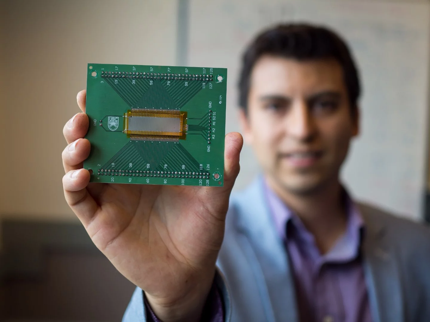 Carlos Gerardo (center), a PhD candidate in electrical and computer engineering at UBC, with his new ultrasound device