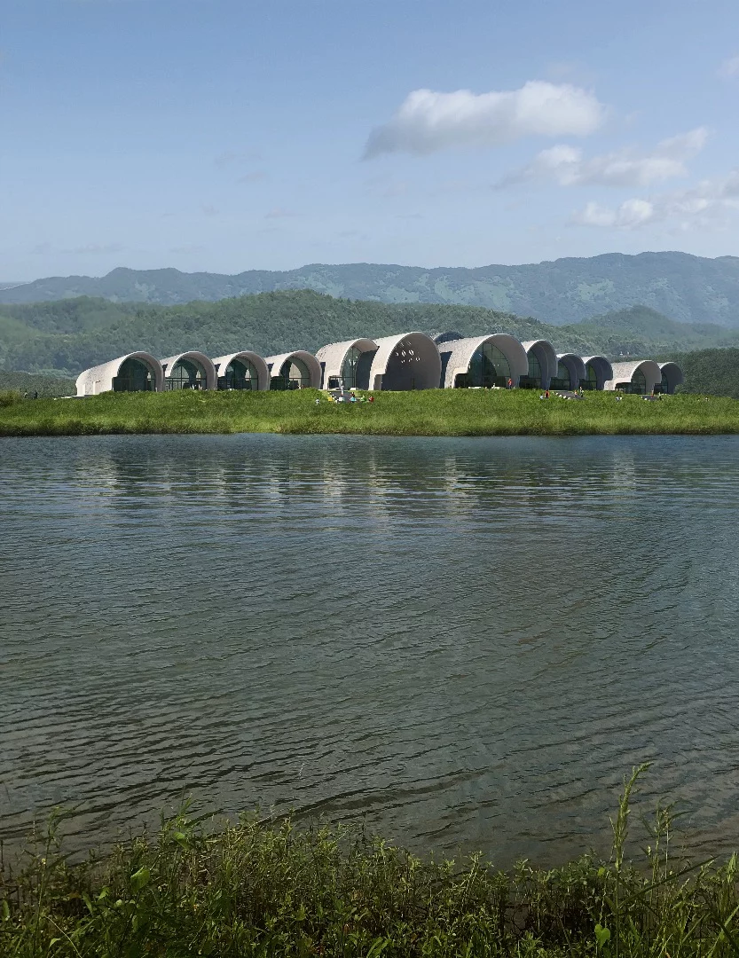 "Composed as a network of barrel and parabolic vaults that open towards the river, the vaults stretch and intersect to accommodate the school’s varied program," says ZHA
