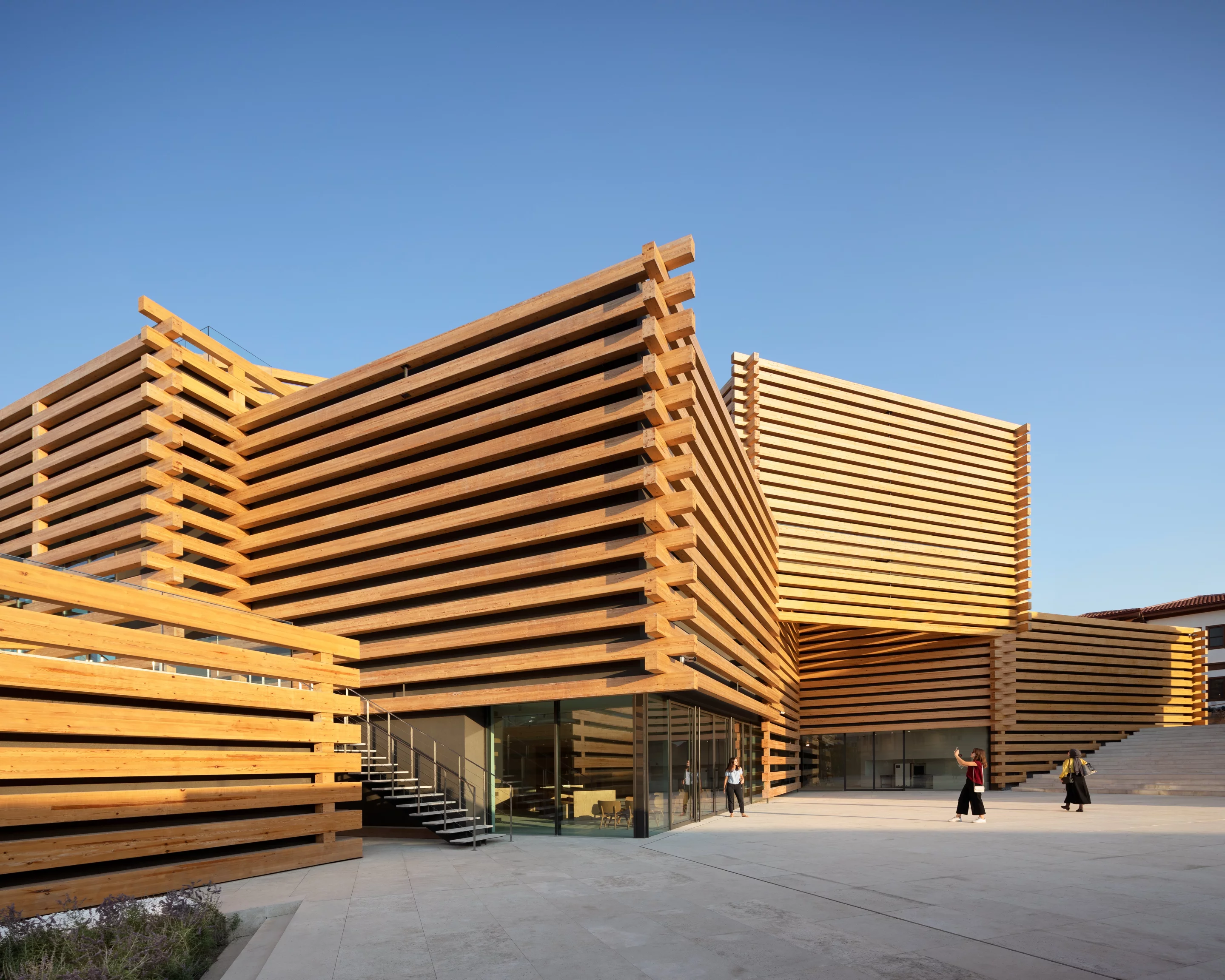 OMM consists of multiple stacked timber-clad boxes
