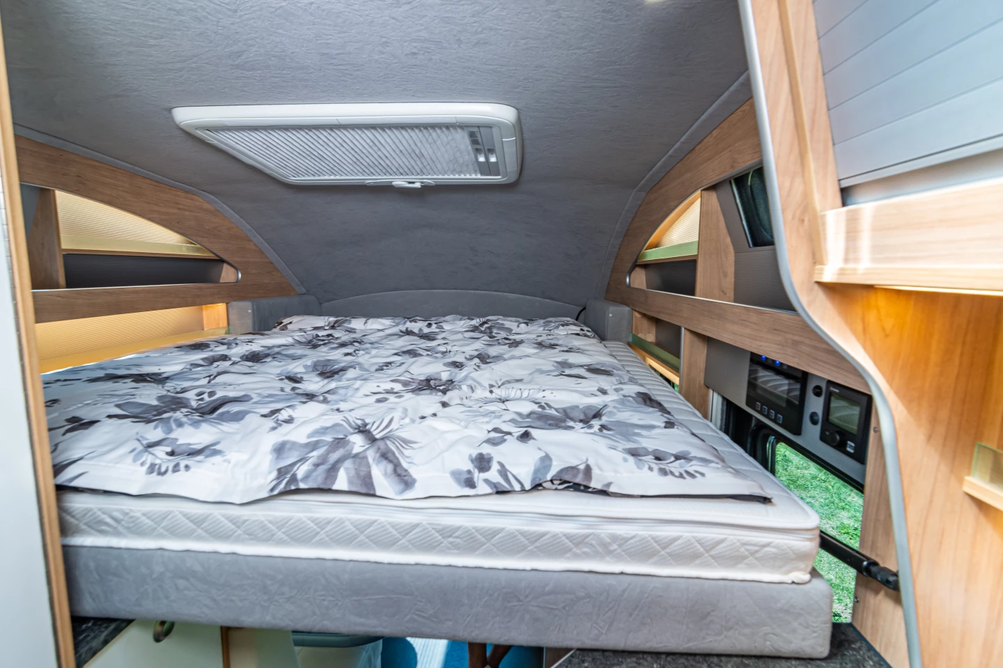 The queen bed drops down in the front of the Nova M motorhome