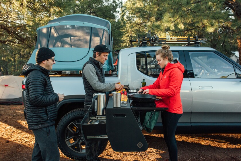 The kitchen's dual-burner electric cooktop pulls power from the vehicle's large 180-kWh battery