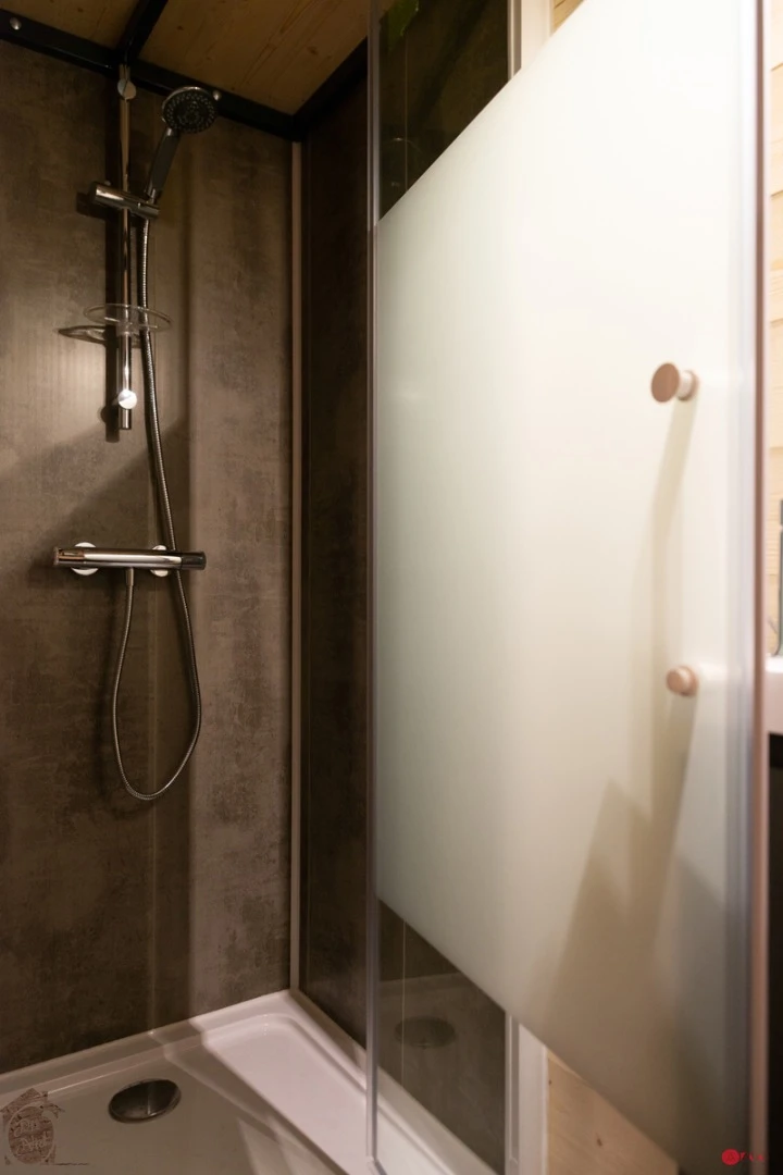 The Axelle's bathroom features a toilet, shower, and sink