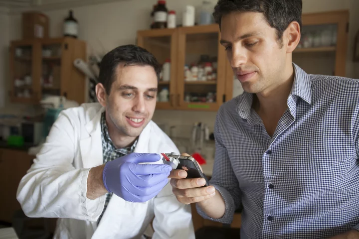 Graduate students Matthew Mancuso (left) and Vlad Oncescu, with the smartCARD