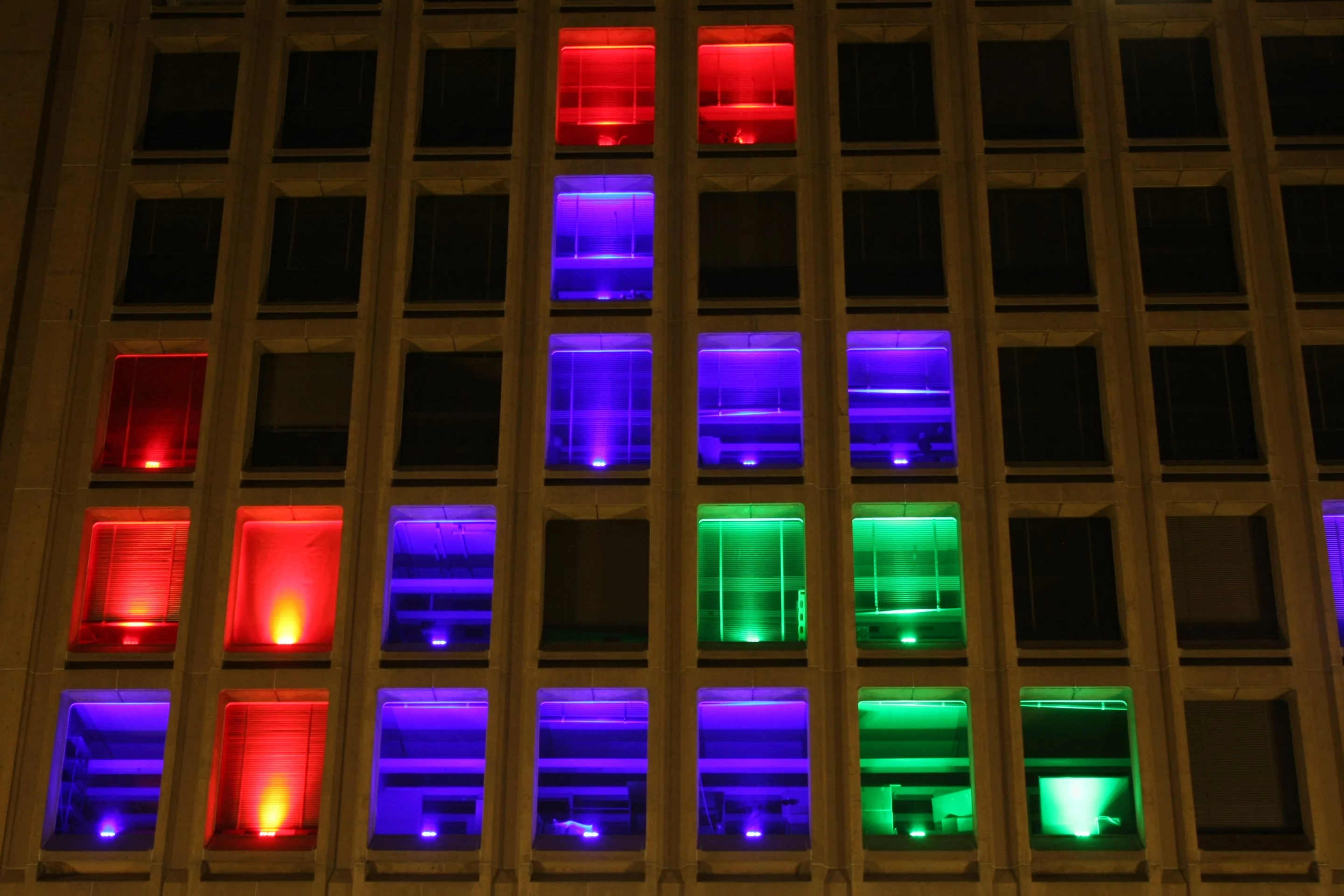 A mysterious group of MIT hackers has taken over the grid of windows on the front of the Institute's Building 54 to create a monster game of Tetris (Photo: Erik Nygren)