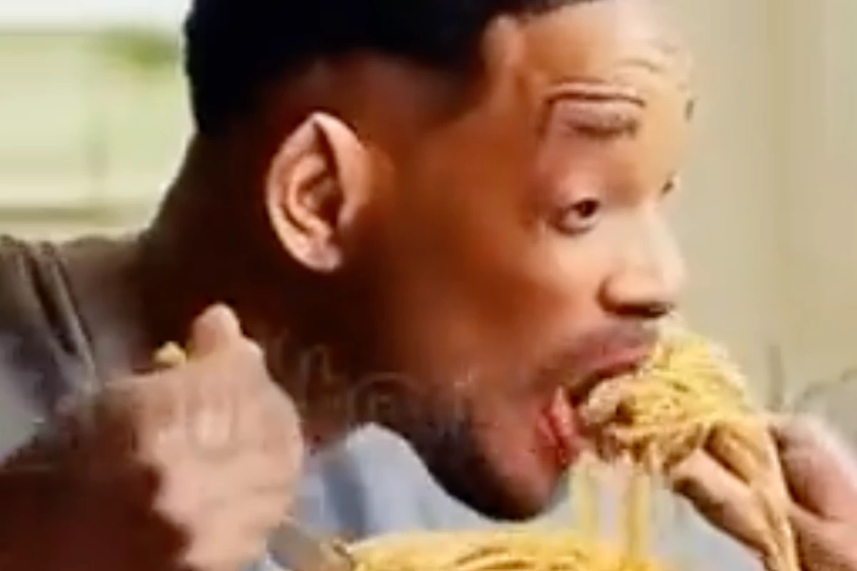 Will Smith eating spaghetti in a video generated by Modelscope, with a faint logo from Shutterstock revealing its source