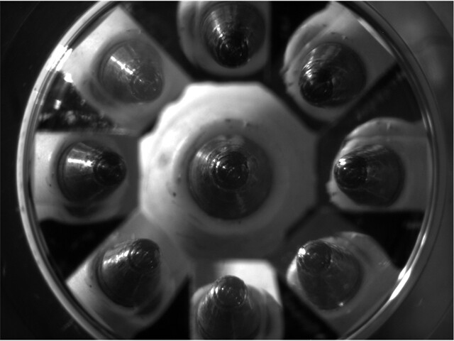 Nine images of the tip of a ballpoint pen, which were combined into one 3D image