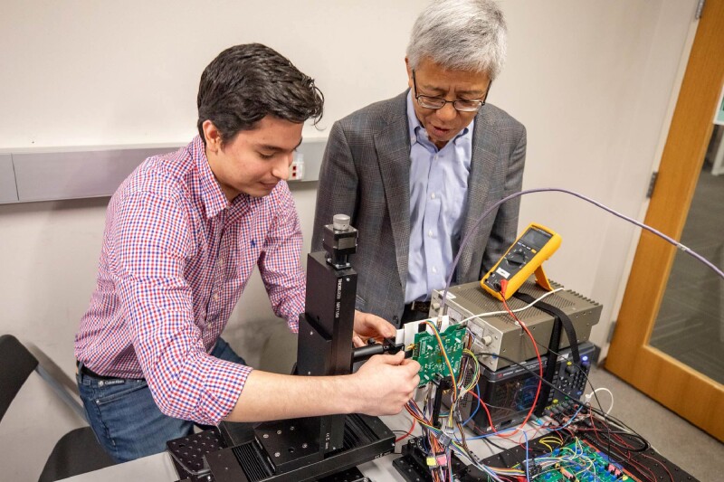 Electrical engineering student Walter Sosa Portillo (left) and Dr. Kenneth O (right) work on the microchip imager for handheld mobile devices.