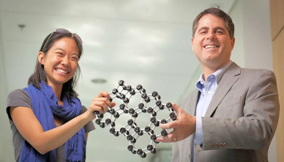 Cornell professor David Muller and grad student Pinshane Huang show a model of the atomic structure of the world's thinnest glass (Photo: Cornell University)