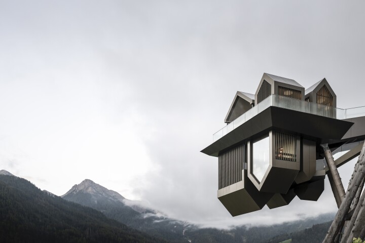 The Hub of Huts is designed to take the form of mountain village huts, some of which have been turned upside down