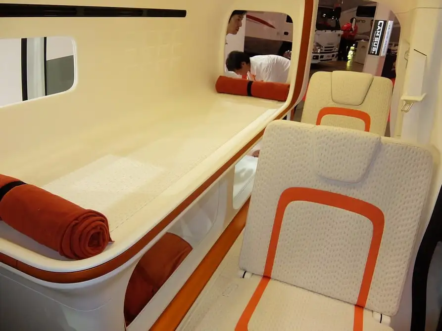 Human and canine TUM Cross City Capsule campers sleep in a purpose-built bunk