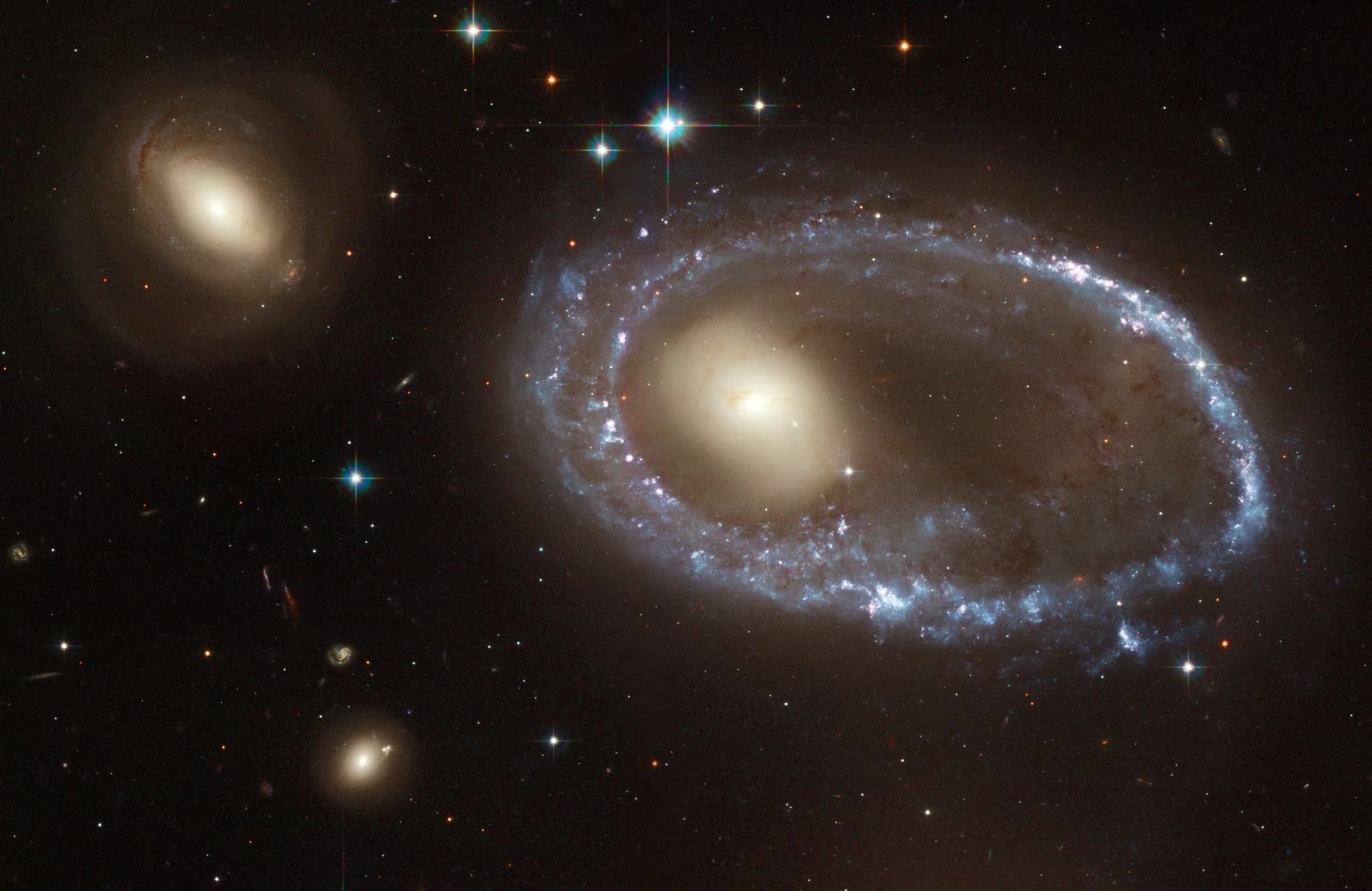 The sparkling blue ring is 150,000 light-years in diameter, making it larger than our entire home galaxy, the Milky Way. The galaxy, cataloged as AM 0644-741, is a member of the class of so- called "ring galaxies." It lies 300 million light-years away in the direction of the southern constellation Dorado