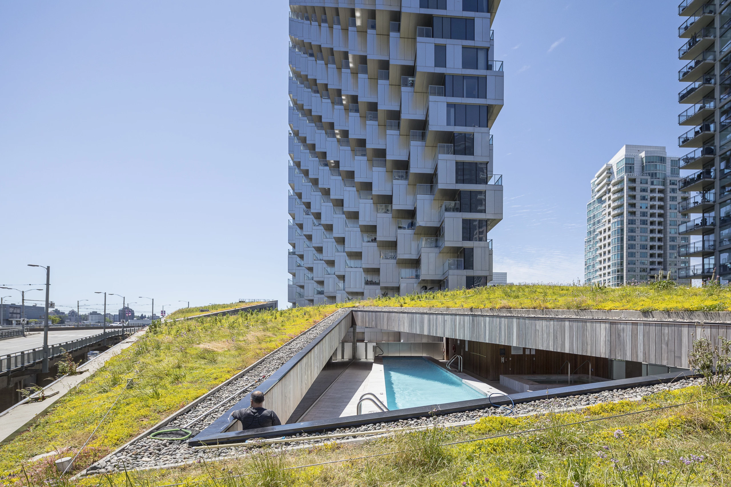 Vancouver House's podium area features a green roof and includes a sheltered outdoor swimming pool