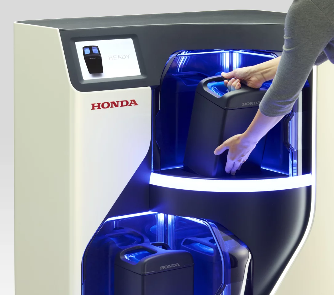 Honda has revealed a battery pack exchange concept that it envisions being located on city street corners, allowing folks to leave a spent pack in situ and pull out a fully charged unit while also serving to stabilize the power grid during peak demand hours