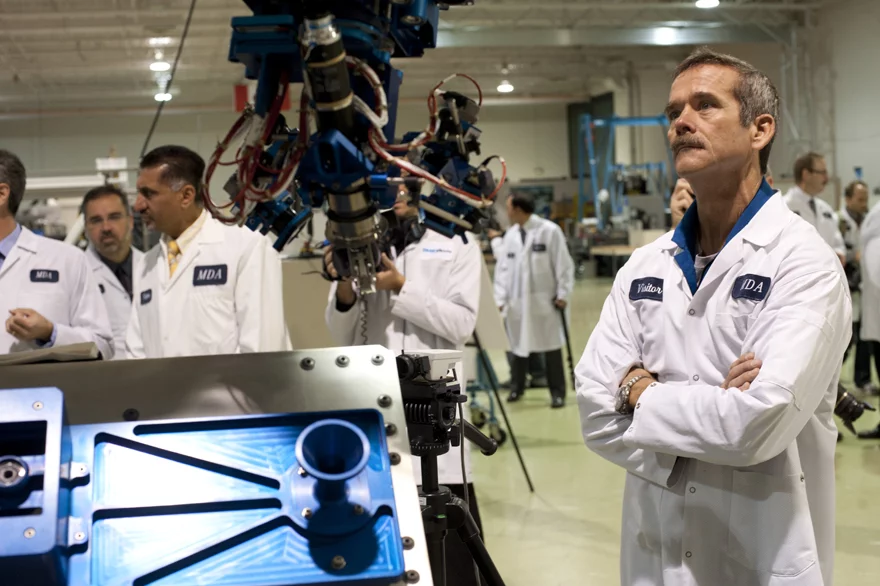 Canadian Astronaut Chris Hadfield looks on at a demonstration of the Next-Generation Canadarm (NGC)