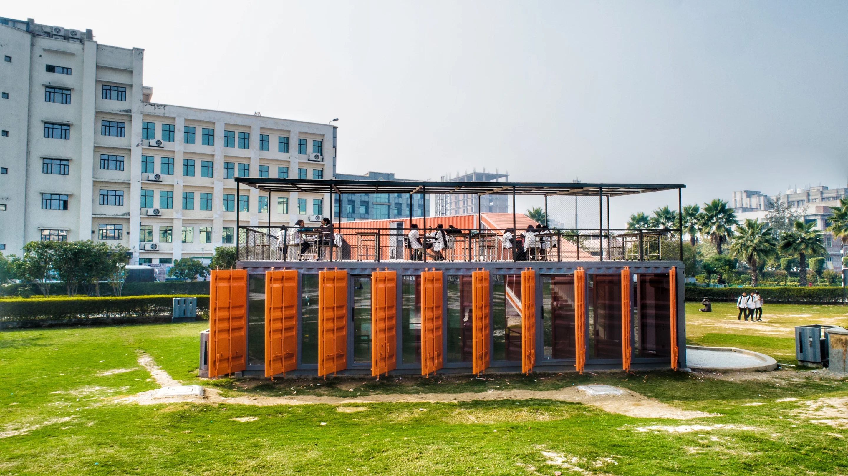 Café Infinity makes use of leftover container doors as louvers, which are used for shading