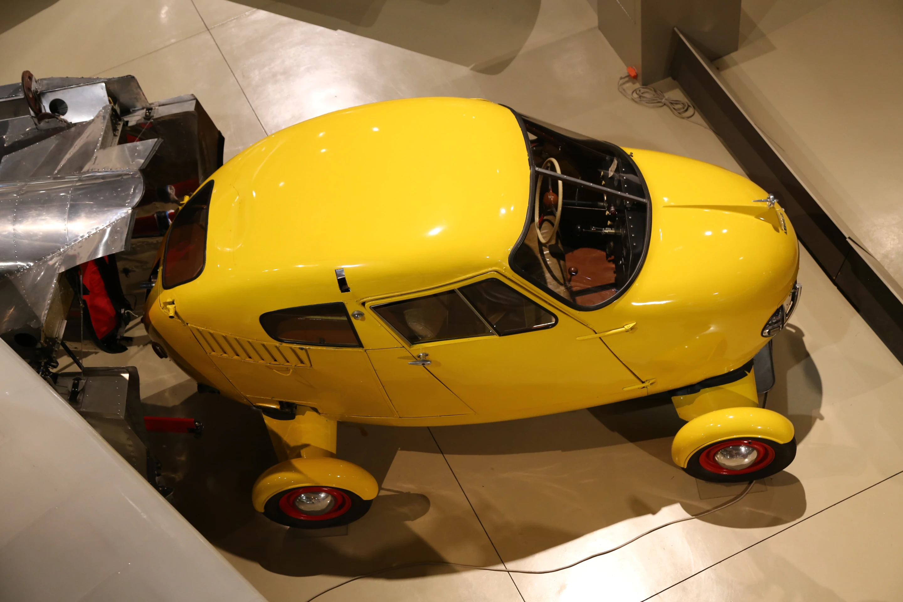 A humorously proportioned flying yellow car on exhibit (Photo: Angus MacKenzie/Gizmag.com)