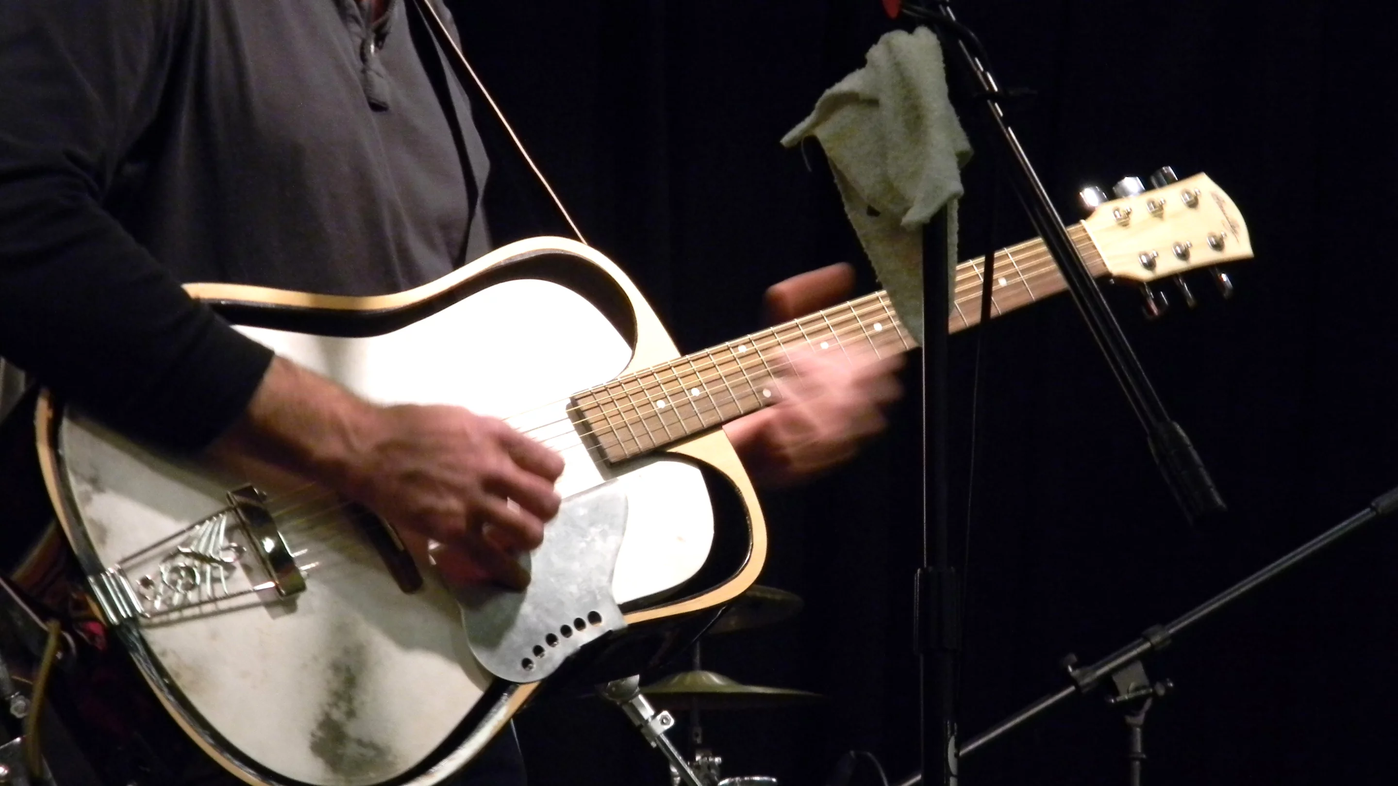 The Bouuillez acoustic in the hands of Mike Rowell at a flood-relief fundraiser