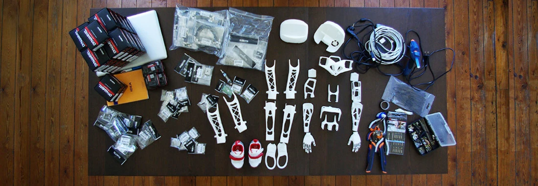 Poppy's 3D-printed parts alongside consumer electronics components (Photo: Inria / H. Raguet)