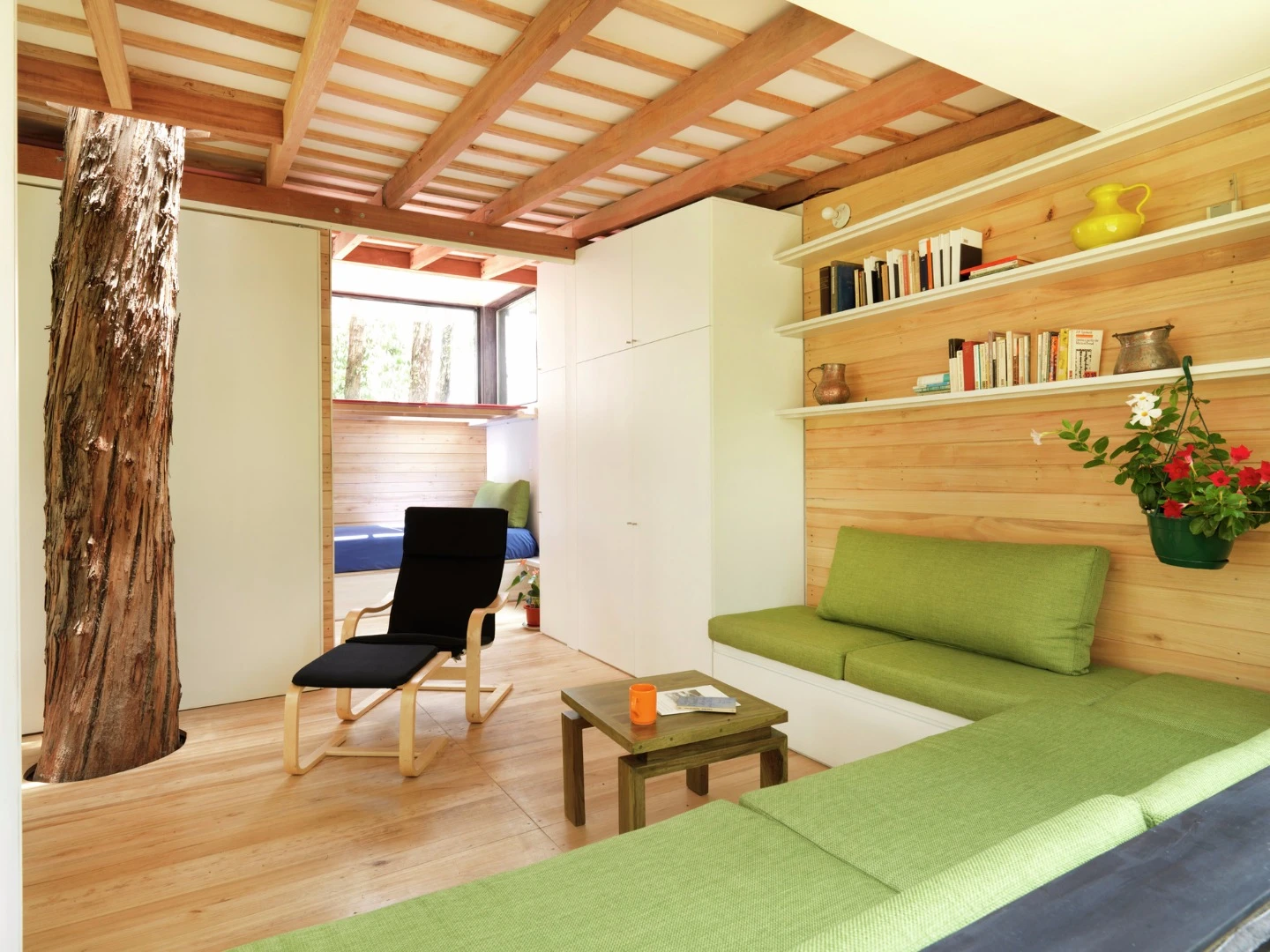 The interior of the home features slimline and built-in furniture, saving on space and materials