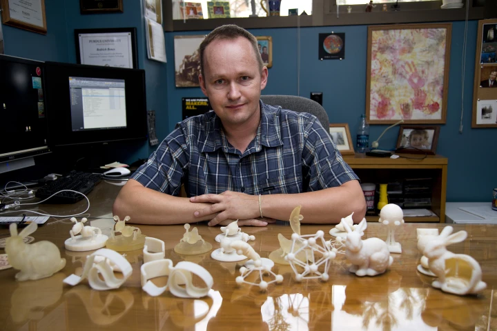 Purdue associate professor of computer graphics Bedrich Benes, with an assortment of objects made with and without the software