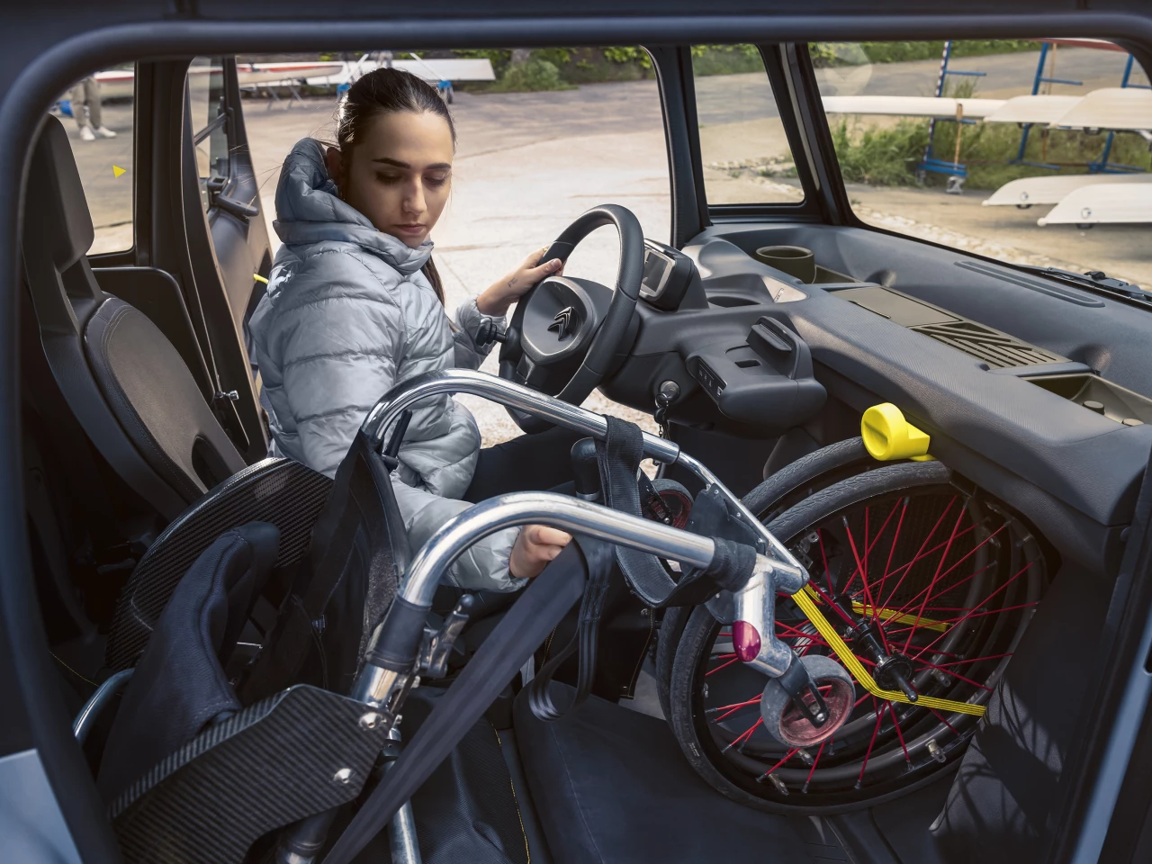 The driver can remove the wheels of a wheelchair and secure them in the passenger footwell, while the remaining folded wheelchair can be strapped into the passenger seat using a specific safety belt