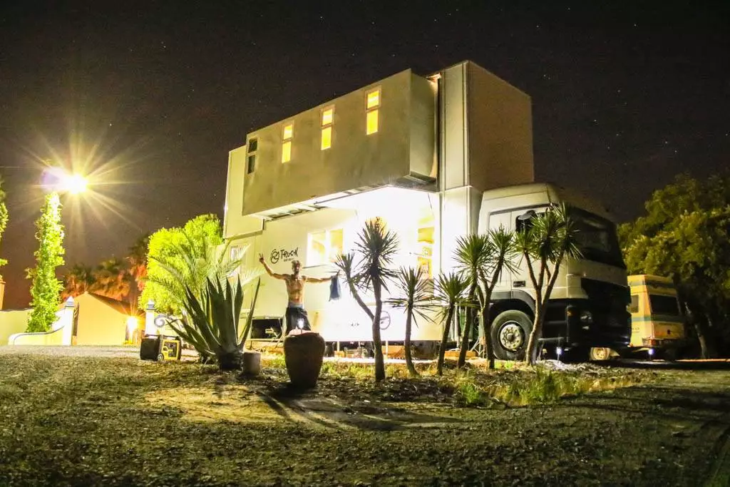 The Truck Surf Hotel lit up after dark