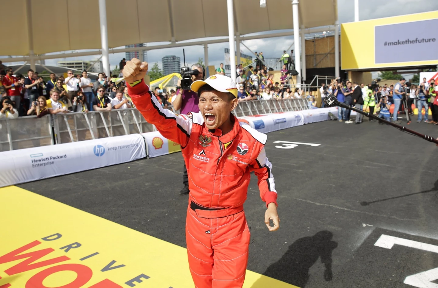 The driver from Bumi Siliwangi Team 4 from Universitas Pendidikan Indonesia, Bandung, Indonesia, celebrates the teams victory in the Drivers' World Championship during Make the Future London 2016