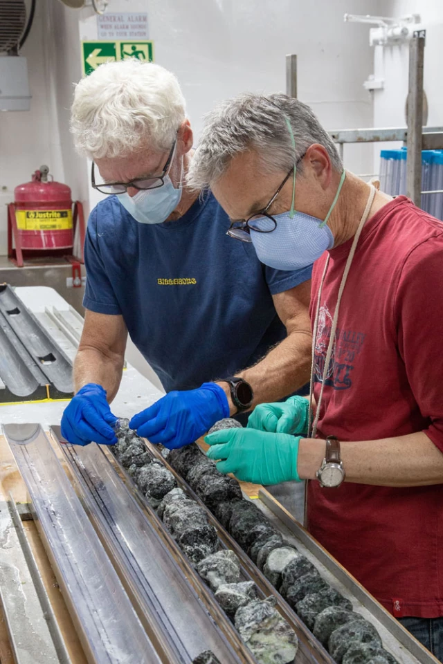Researchers Gordon Southam and Johan Lissenberg studying samples of the mantle rock cores