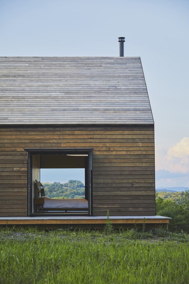 A newly finished dwelling in upstate New York takes careful cues from traditional farm buildings of the area, but makes every effort to afford it inhabitants the comfort of a modern home