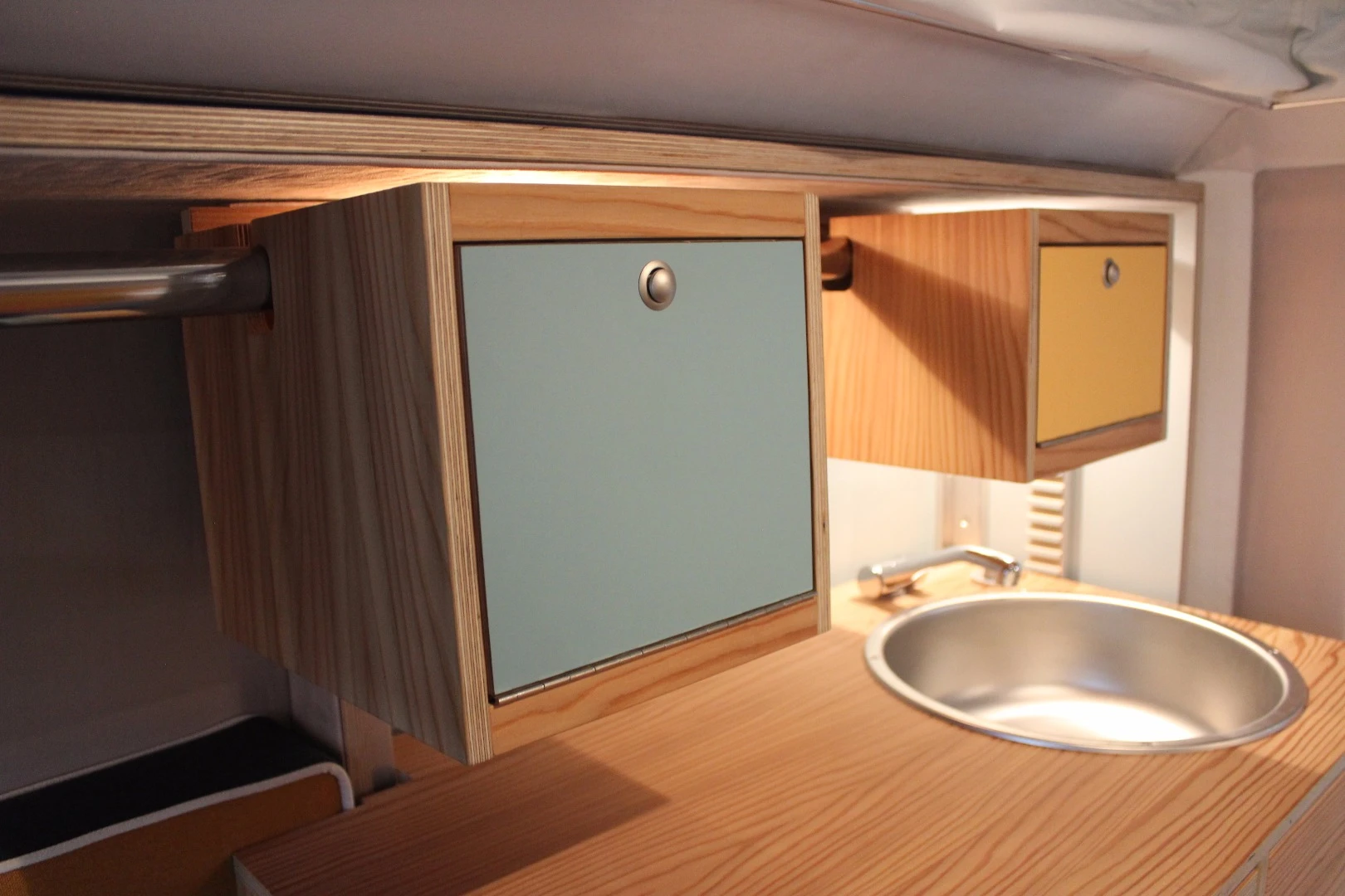 The cabinets are located on a rod so they can slide out of the way for kitchen access