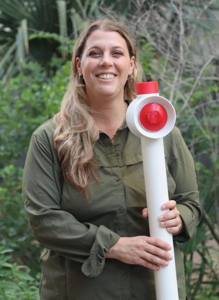 Assoc. Prof. Daniella Rempe holds a 3D-printed model of the flood alarm she is developing