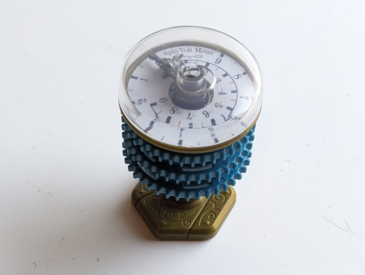 The "capacitor" is a spring-loaded device that stores kinetic energy and releases it