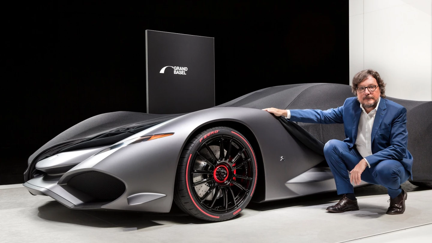 Andrea Zagato and his Zagato IsoRivolta Vision Grand Turismo Concept. The covers were only partially removed, with the full reveal planned for October when it will be available digitally as part of the Sony Playstation game series, Gran Turismo Sport. The concept is expected to be presented in full at Grand Basel 2018.