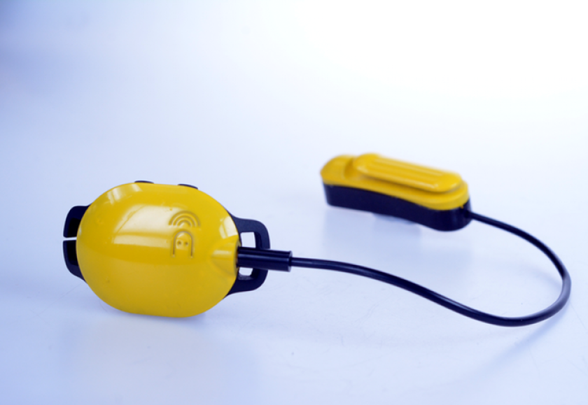 Marlin's waterproof main control unit attaches the user's goggle strap, and is hard-wired to the earpiece