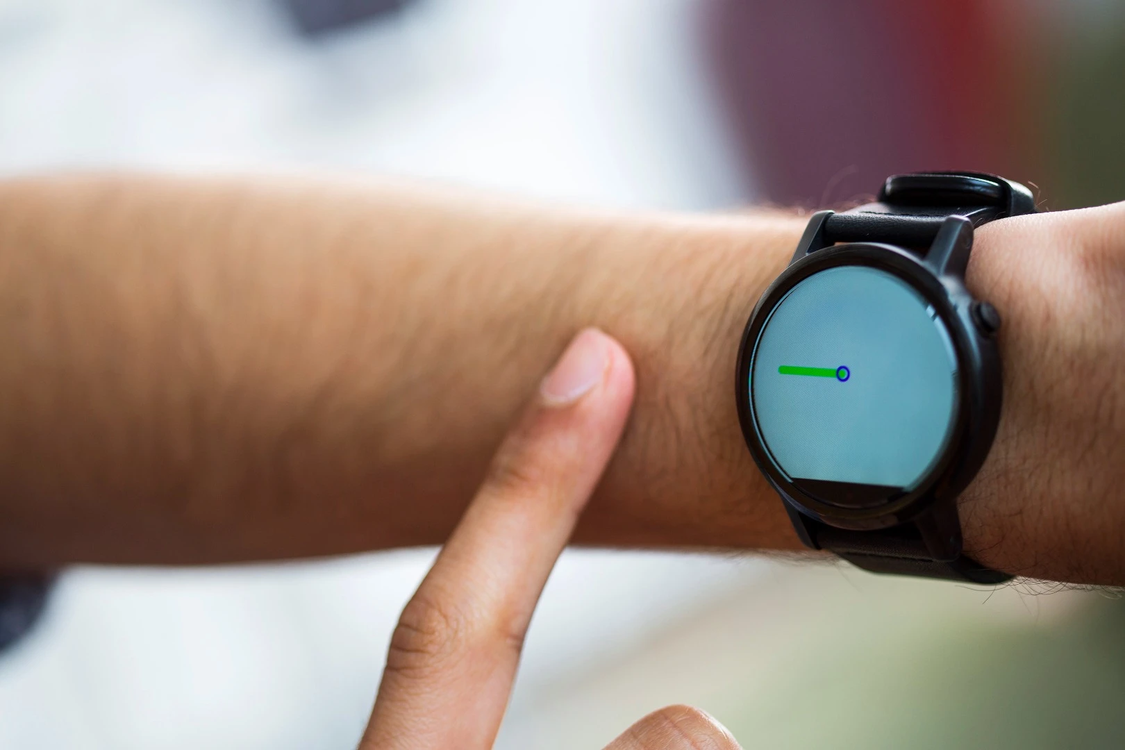 A FingerIO-equipped smartwatch tracks a user's finger as it draws a line on their arm