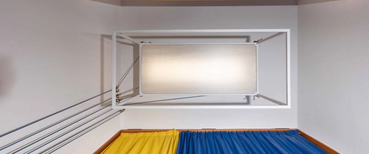 The dining table features a semi-transparent honeycomb top, which allows diffused light to filter down into the living area