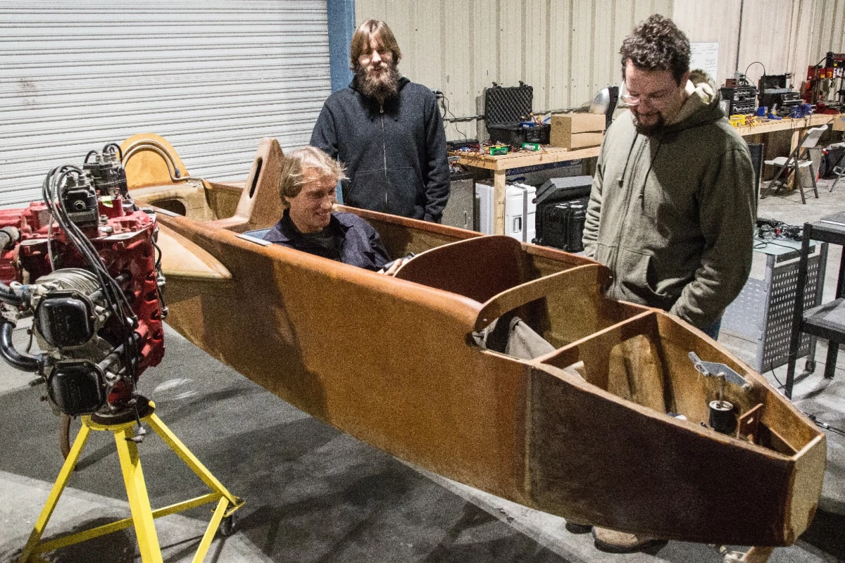 Dezso Molnar checks out the aircraft chassis he's converting to electric with Craig Calfee. Also pictured: Luke Workman and Gabe DeVault, who are spearheading the power plant integration.